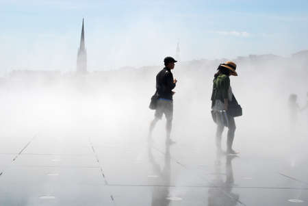 tourists with steam in the fountain of La Bourse in Bordeauxのeditorial素材