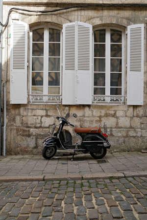 Vintage italian retro scooter in the street of Bourgesの写真素材