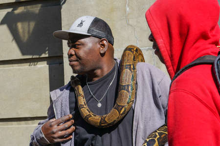 New Orleans - 04/15/2018: Black man with snake around neckのeditorial素材