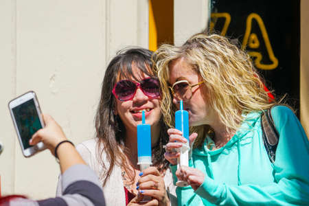 New Orleans - 04/15/2018: girls enjoying a jello syringe shot, a spooky cocktailのeditorial素材