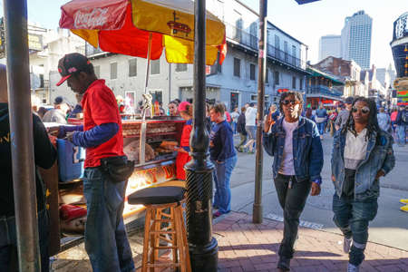 New Orleans - 04/15/2018: street scene with people walking and take away hot dogのeditorial素材