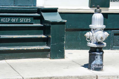 New Orleans - 04/15/2018: Fire hydrant and green stairs on the sidewalkのeditorial素材