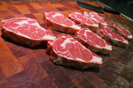 Higgins family butcher, rib eye on the chopping board, prepared for a customer.Rare Breed Beef is expertly aged and cut to perfectionのeditorial素材