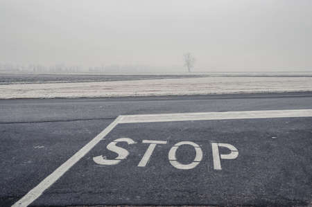 Gravellona Lomellina - 12/30/2011: stop road sign covered with frost in winter in a foggy dayの写真素材