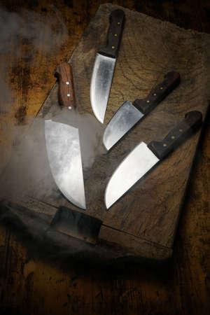 Mortara 09/10/2019: different size kitchen knives on wooden cutting board and steamの写真素材