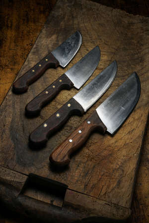 Mortara 09/10/2019: kitchen knives lined up on wooden cutting boardの写真素材