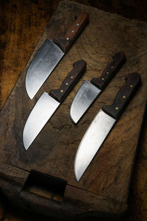 Mortara 09/10/2019: kitchen knives lined up on wooden cutting boardの写真素材