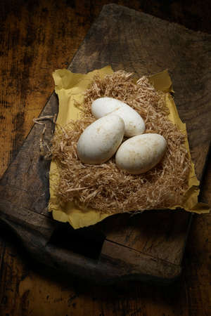 Mortara 09/10/2019: goose eggs on straw and wooden tableの写真素材