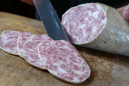 Mortara 04/05/2019: slicing the goose salamiの写真素材
