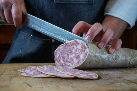 Mortara 04/05/2019: slicing the goose salamiの写真素材