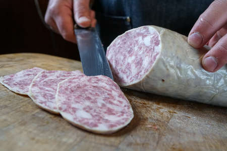 Mortara 04/05/2019: slicing the goose salamiの写真素材