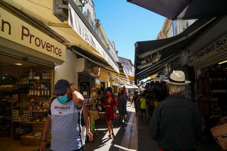 Saintes Maries de la Mer - 09/04/2020: tourists in a traditional street of Saintes Maries de la Merのeditorial素材