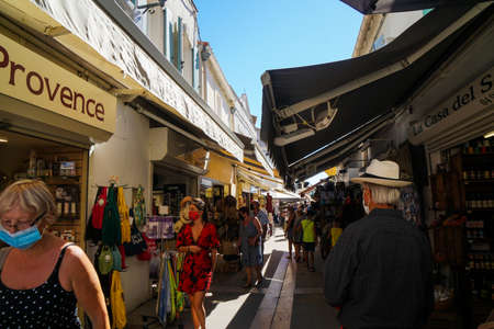 Saintes Maries de la Mer - 09/04/2020: tourists in a traditional street of Saintes Maries de la Merのeditorial素材