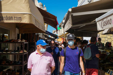 Saintes Maries de la Mer - 09/04/2020: tourists with mask protection walking in the streetのeditorial素材
