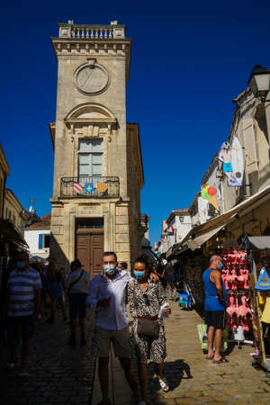 Saintes Maries de la Mer - 09/04/2020: tourists in a street and in the background Baroncelli museum buildingのeditorial素材