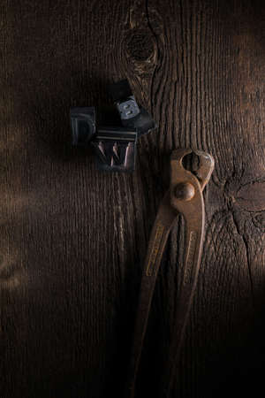 Florence - 04/03/2019: still life of pincer and lead typefaces on a wooden tableの写真素材