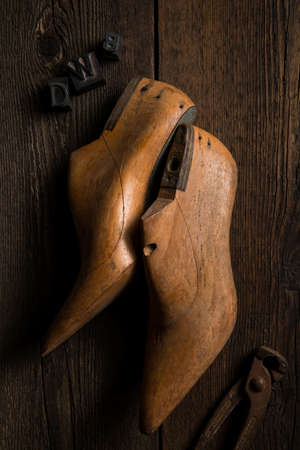 wooden shape models for making shoes with pincer on a wooden tableの写真素材