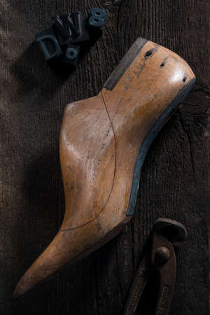 wooden shape models for making shoes with pincer on a wooden tableの写真素材