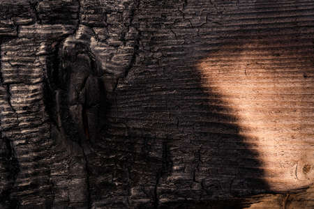 close up black scratched wooden background. Details on the surface of charcoalの写真素材