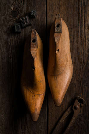 wooden shape models for making shoes with pincer on a wooden tableの写真素材