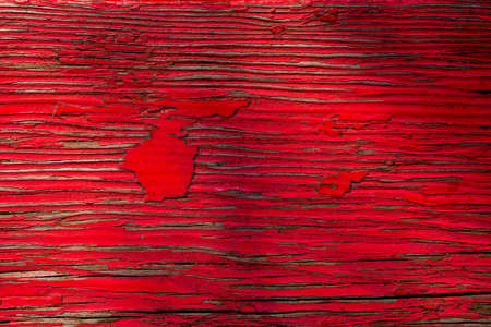 Background of wooden plank with peeling red paintの写真素材