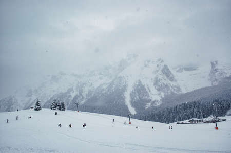 Madonna di Campiglio, Trentino Alto Adige, Italy - 01/28/06: skiers and ski lifts in winter in a snowy dayの写真素材