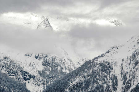 Madonna di Campiglio, Trentino Alto Adige, Italy - 01/28/06: the Dolomites snow-capped mountains and a snowy skyの写真素材