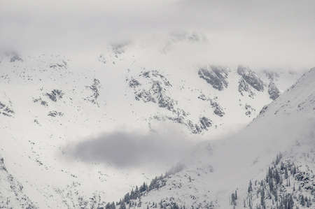 Madonna di Campiglio, Trentino Alto Adige, Italy - 01/28/06: the Dolomites snow-capped mountains and a snowy skyの写真素材