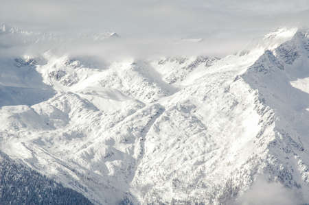 Madonna di Campiglio, Trentino Alto Adige, Italy - 01/28/06: the Dolomites snow-capped mountains and a snowy skyの写真素材
