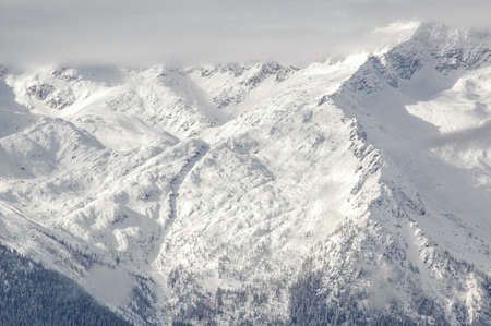 Madonna di Campiglio, Trentino Alto Adige, Italy - 01/28/06: the Dolomites snow-capped mountains and a snowy skyの写真素材