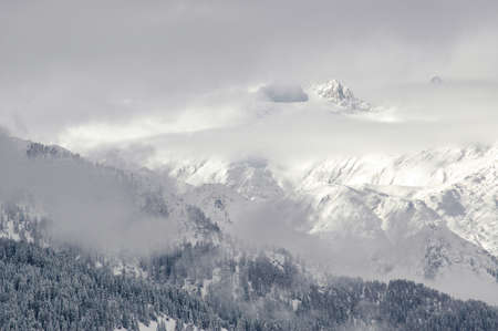 Madonna di Campiglio, Trentino Alto Adige, Italy - 01/28/06: the Dolomites snow-capped mountains and a snowy skyの写真素材