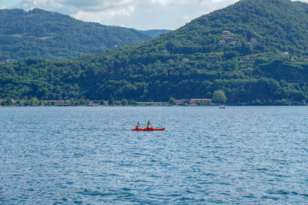 Pella - 07/12/2020: couple on a red canoe in Orta's lakeのeditorial素材