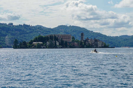 Pella - 07/12/2020: view of Isle San Giulio with nautical dinghyのeditorial素材
