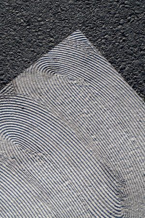 geometrical white painting of pedestrian crossing with texture on asphaltの写真素材