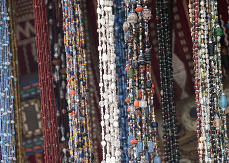Moroccan bead stall with necklaces hung across itの写真素材