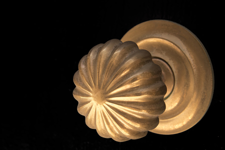 Essaouria, Morocco - September 2017: worn bronze door knob isolates on black backgroundのeditorial素材