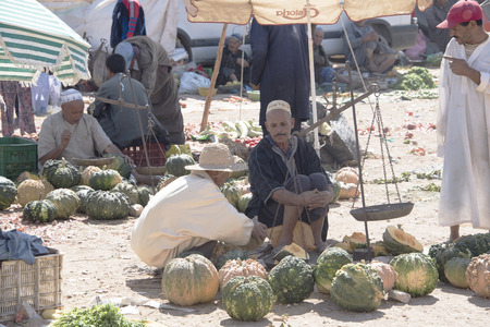 Essaouria, Morocco - September 2017: A farmer sits waitnig to sell his produce at the weekly berber open market outside Essaouira in Morocco. Women rarely attend a market like this one.のeditorial素材