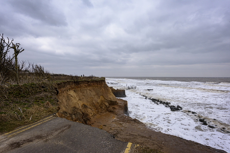 UK, HAPPISBURGH - 18 MAR 2018: Coastal erosion taking place during a winter storm. Many homes have recently been lost in this community due to the sea eating away the coastline.のeditorial素材