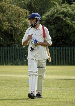 LOUGHBOROUGH, UK - July 2017 - Man walking out to bat at local charity cricket matchのeditorial素材