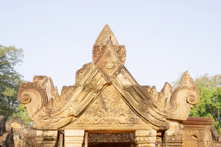 Cambodia, Banteay Seay - March 2016 - Decorative lintels in reconstructed ruins of ornately carved 10th-century, red sand stone, temple dedicated to the Hindu god Shiva, bathed in the early morning lightのeditorial素材
