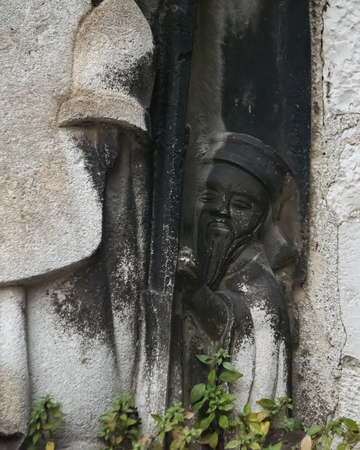 Croatia, Split - June 2018: Carving of an oriental styled figure as he peeps out from around a larger statue at The Cathedral of Saint Domnius, part of the Diocletian Palaceのeditorial素材