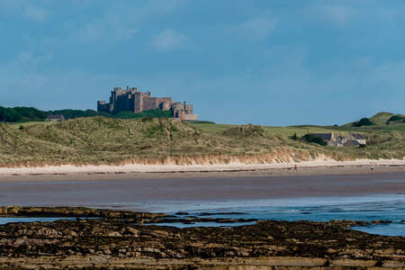 UK, Bamburgh - June 2019: Bamburgh Castle viewed from the coastのeditorial素材