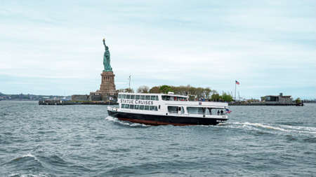 USA, New York - May 2019: Ferry Boat approaching the Statue of Liberty, Liberty Islandのeditorial素材