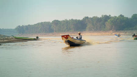 Cambodia, Tonle Sap Floating Village - March 2016: Man driving traditional long boat, water taxiのeditorial素材