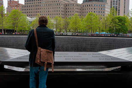 USA, New York - May 2019: Man pauses at 9/11 monument, World Trade Centre