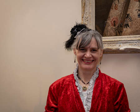 UK, Market Bosworth, Victorian Christmas Fair - December 2015: Lady dresses in a red victorian dress.のeditorial素材