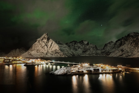 Aurora Over an Illuminated Bridge in Lofoten, Norway at Nightの写真素材