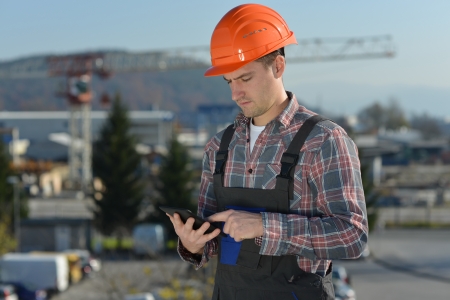 Engineer at construction site, an image from the construction industry of a worker with a computer...