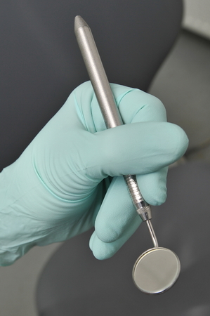 Dental angled mirror, Dentist hand with gloves の写真素材