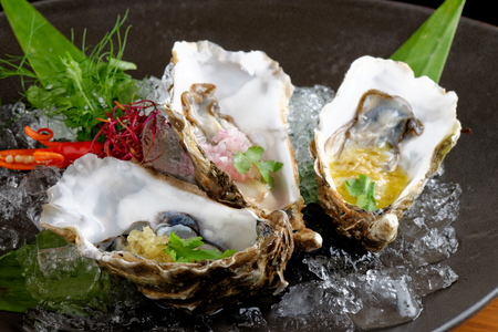 Fresh Oysters with three sauces (cilantro with lime juice, ginger vanilla and pinneaple with chili)の写真素材